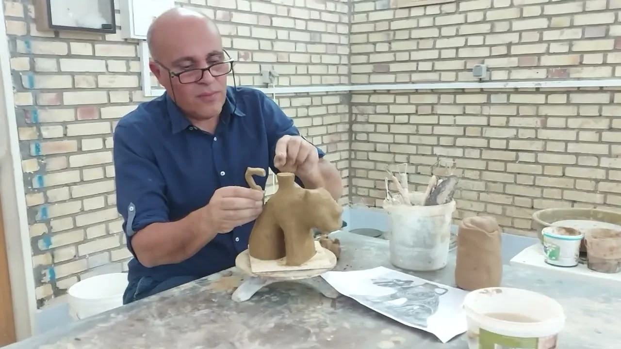 Abbas Akbari modelling in clay in his studio in Kashan